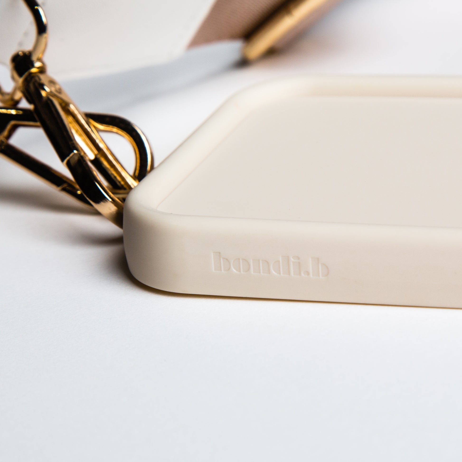 Stylish crossbody phone case with nude colour adjustable strap, designed for convenience and hands-free use. Features a secure cream colour phone case holder and has a sleek design making it perfect for everyday minimalist wear.